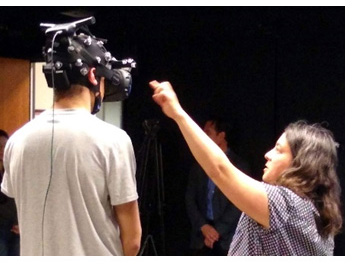 A subject participates in a listening experiment in the Auditory Learning & Cognition Lab